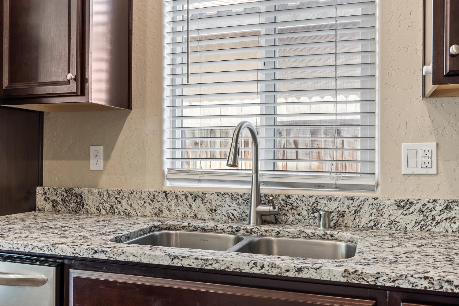 701 Strada Street Lemoore, CA 93245 - Photo 10 of 25 a bathroom with a granite countertop sink and a window