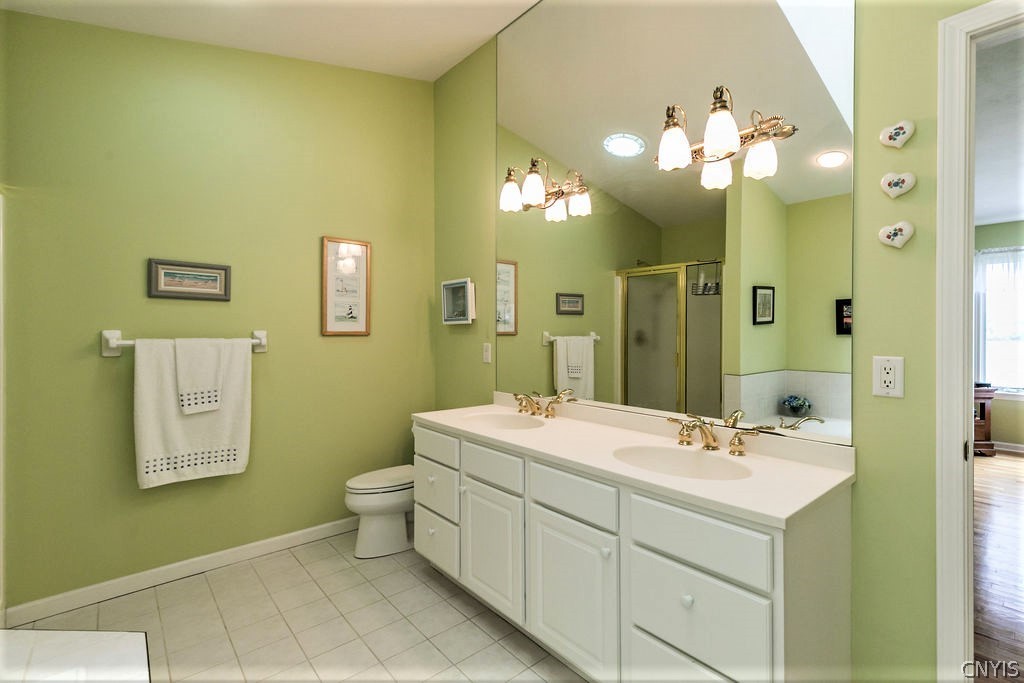 231 Oarlock Circle Manlius, NY 13057 - Photo 23 of 35 A double vanity and ceramic tiles complete this ro