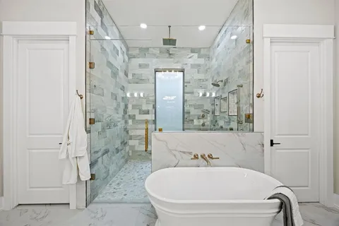 a bathroom with a tub and a shower
