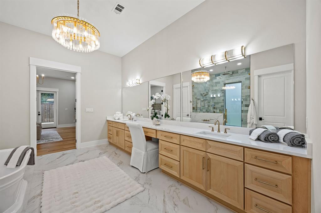 4208 Allencrest Lane Dallas, TX 75244 - Photo 16 of 40 a spacious bathroom with a double vanity sink and a mirror