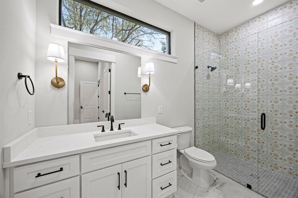 4208 Allencrest Lane Dallas, TX 75244 - Photo 19 of 40 a bathroom with a toilet a sink a mirror a window and vanity