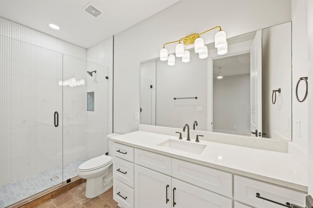 4208 Allencrest Lane Dallas, TX 75244 - Photo 21 of 40 a bathroom with a sink a toilet and shower