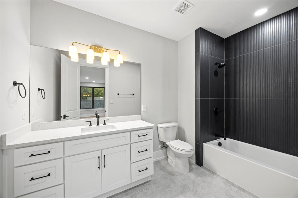 4208 Allencrest Lane Dallas, TX 75244 - Photo 23 of 40 a bathroom with a double vanity sink toilet mirror and bathtub