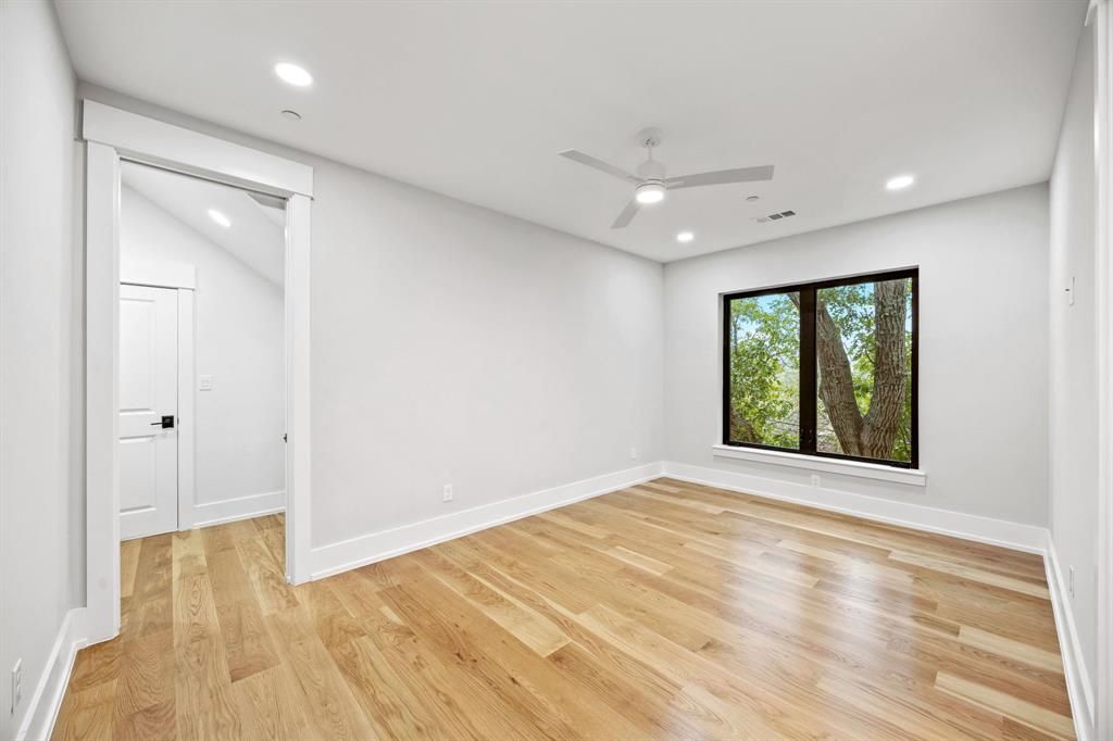4208 Allencrest Lane Dallas, TX 75244 - Photo 24 of 40 a view of an empty room with wooden floor and a window