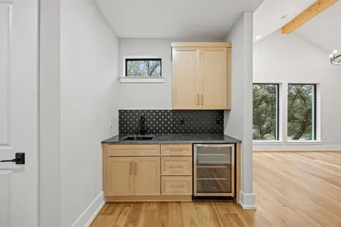 a kitchen with granite countertop a stove and a wooden floor