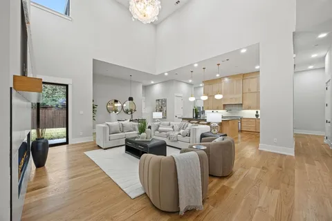 a living room with fireplace furniture and a wooden floor