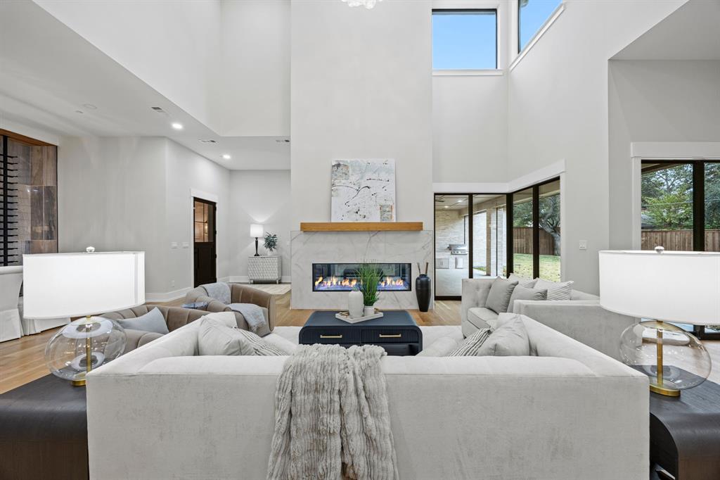 4208 Allencrest Lane Dallas, TX 75244 - Photo 6 of 40 a living room with furniture a fireplace and a large mirror