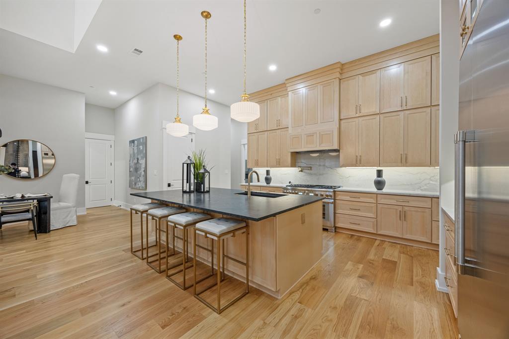 4208 Allencrest Lane Dallas, TX 75244 - Photo 8 of 40 a large kitchen with kitchen island a sink and a stove top oven