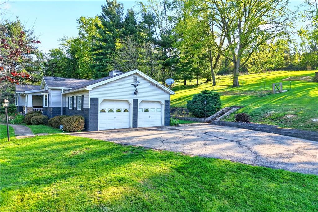 1188 Willowbrook Road Belle Vernon, PA 15012 - Photo 11 of 50 a front view of a house with a yard and garage