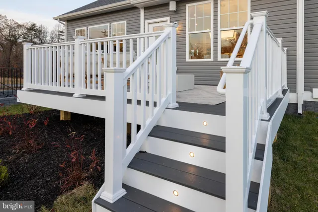a view of entryway with wooden floor and stairs