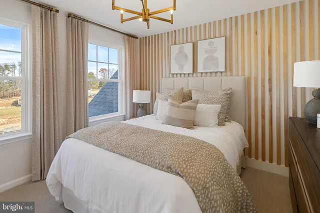 a spacious bedroom with a bed and a window