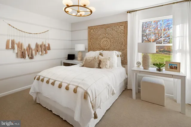 a spacious bedroom with a bed and a table