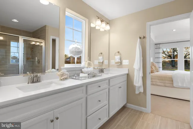 a en suite bathroom with double vanity and a mirror