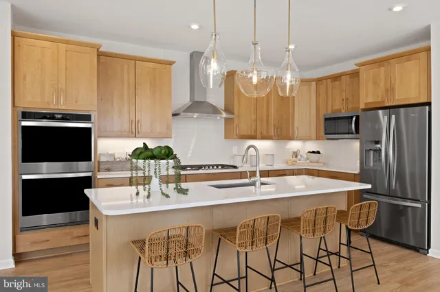 a kitchen with stainless steel appliances a sink stove and refrigerator