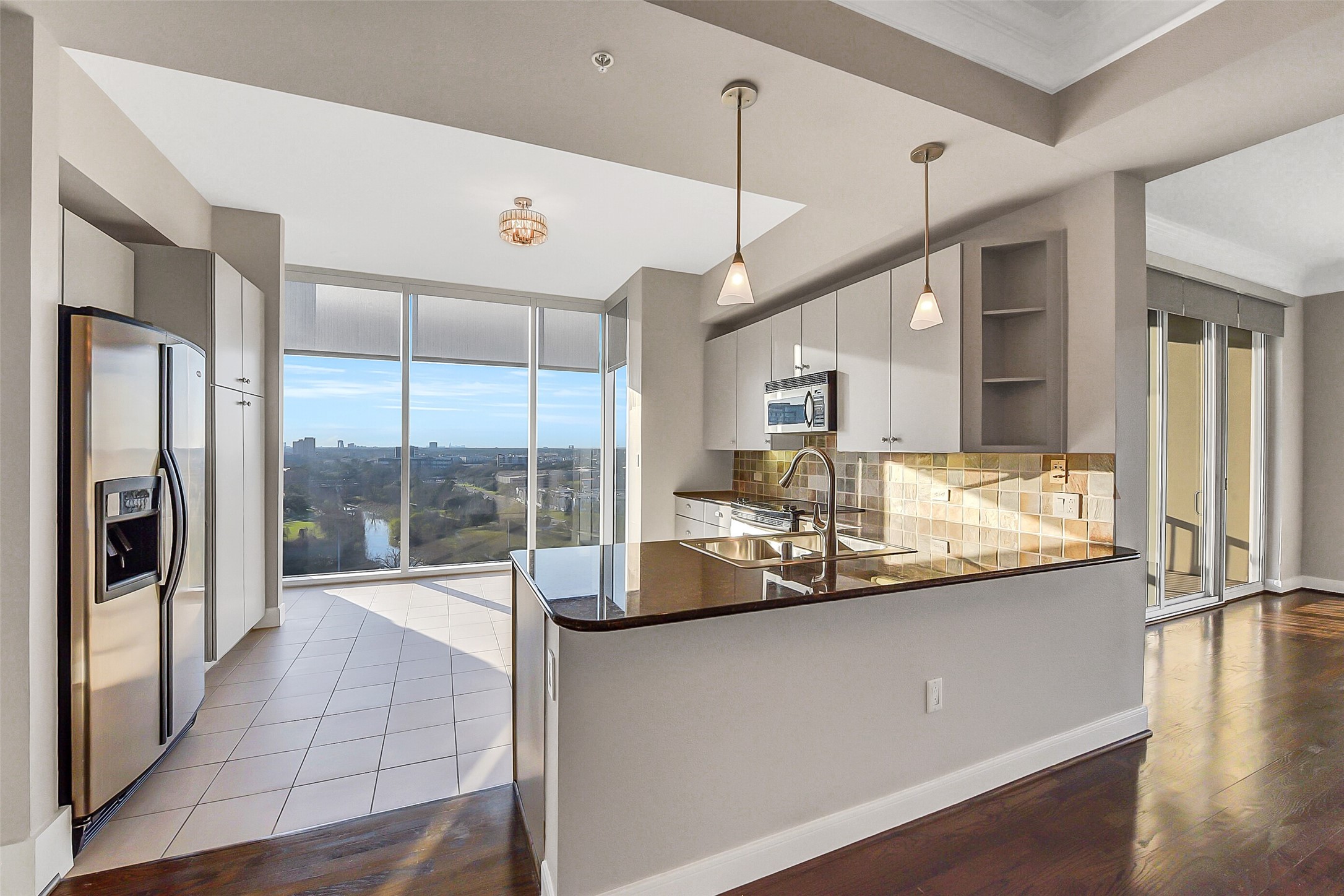 3333 Allen Parkway, Unit 1609 Houston, TX 77019 - Photo 4 of 33 Designed for convenience, this large kitchen offers a versatile layout with space for casual dining or an island. Elegant pendant lights accent the bar area, which is complemented by abundant storage and included appliances, including the refrigerator