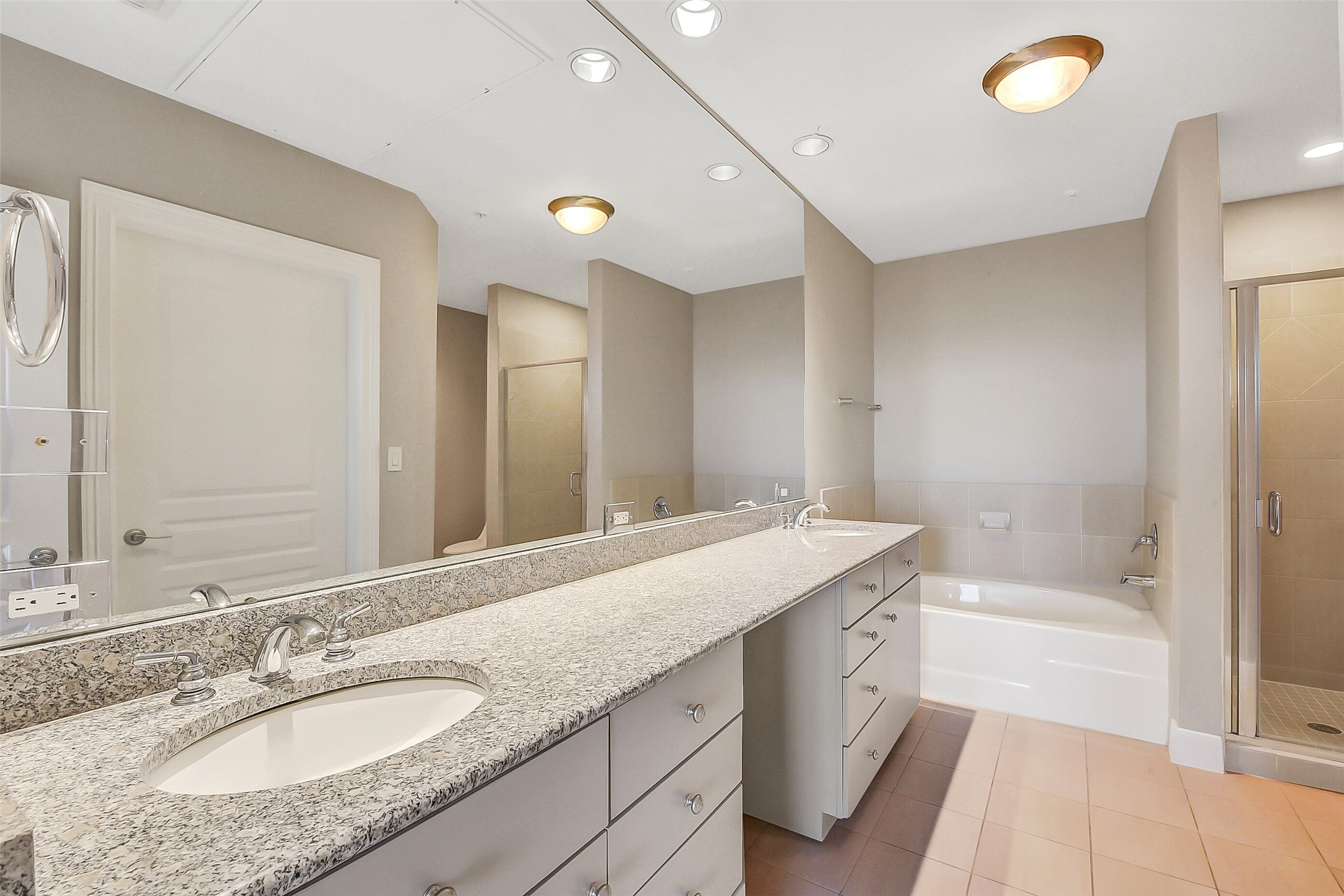 3333 Allen Parkway, Unit 1609 Houston, TX 77019 - Photo 8 of 33 Primary bath with dual-sink stone vanity, large soaking tub, walk-in shower, and ample storage