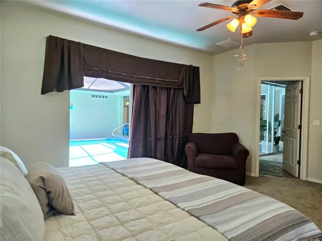 a spacious bedroom with a bed and a chandelier