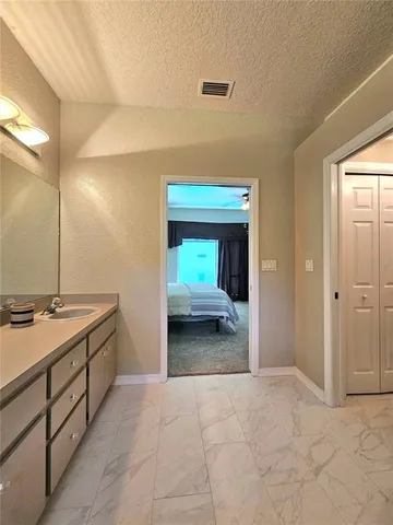 a bathroom with a sink a toilet a tub and mirror