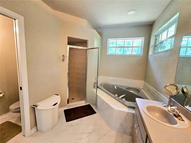 a bathroom with a double vanity sink a mirror and a shower