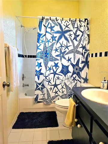 a bathroom with a sink and a mirror with toilet