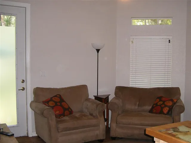 a view of a workspace with furniture and a window