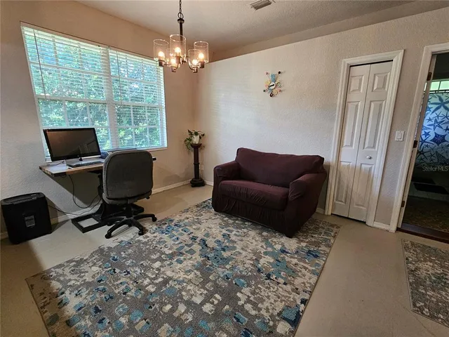 a living room with furniture a window and a flat screen tv
