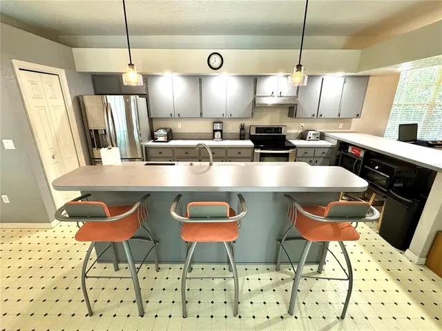 a large kitchen with a table and chairs