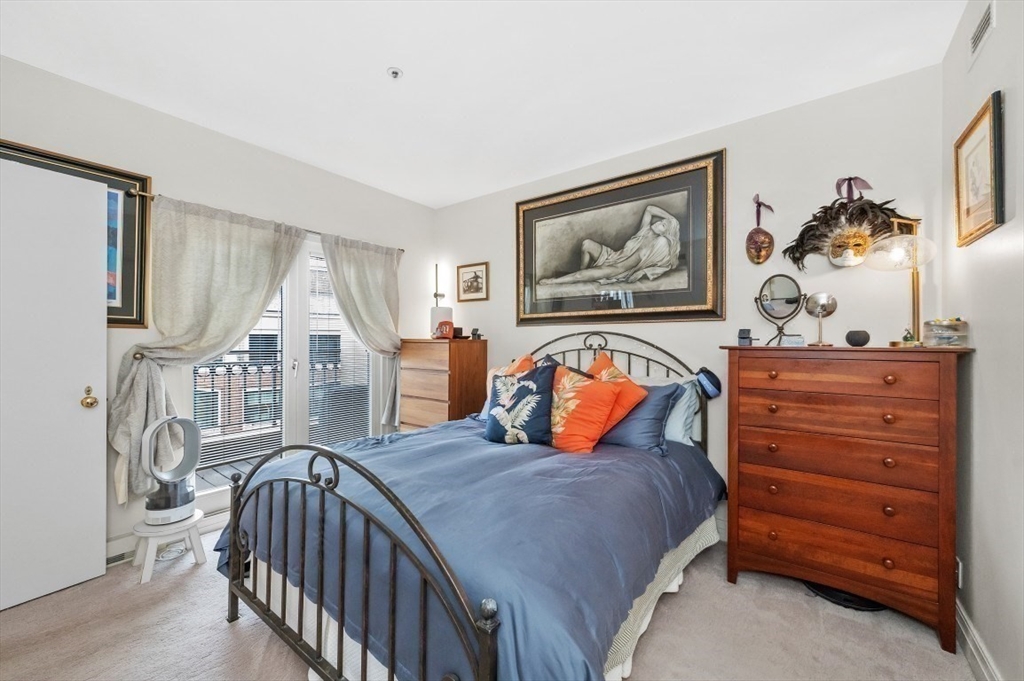 20 Rowes Wharf, Unit PH4 Boston, MA 02110 - Photo 11 of 24 a bedroom with furniture and baby crib