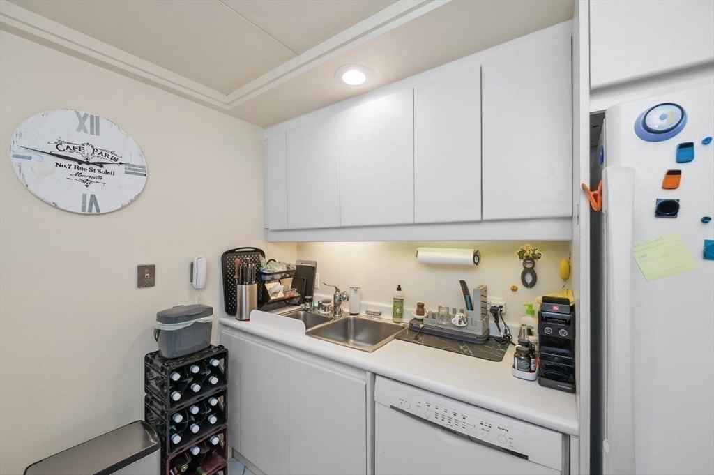 20 Rowes Wharf, Unit PH4 Boston, MA 02110 - Photo 13 of 24 a kitchen with a sink a stove and cabinets