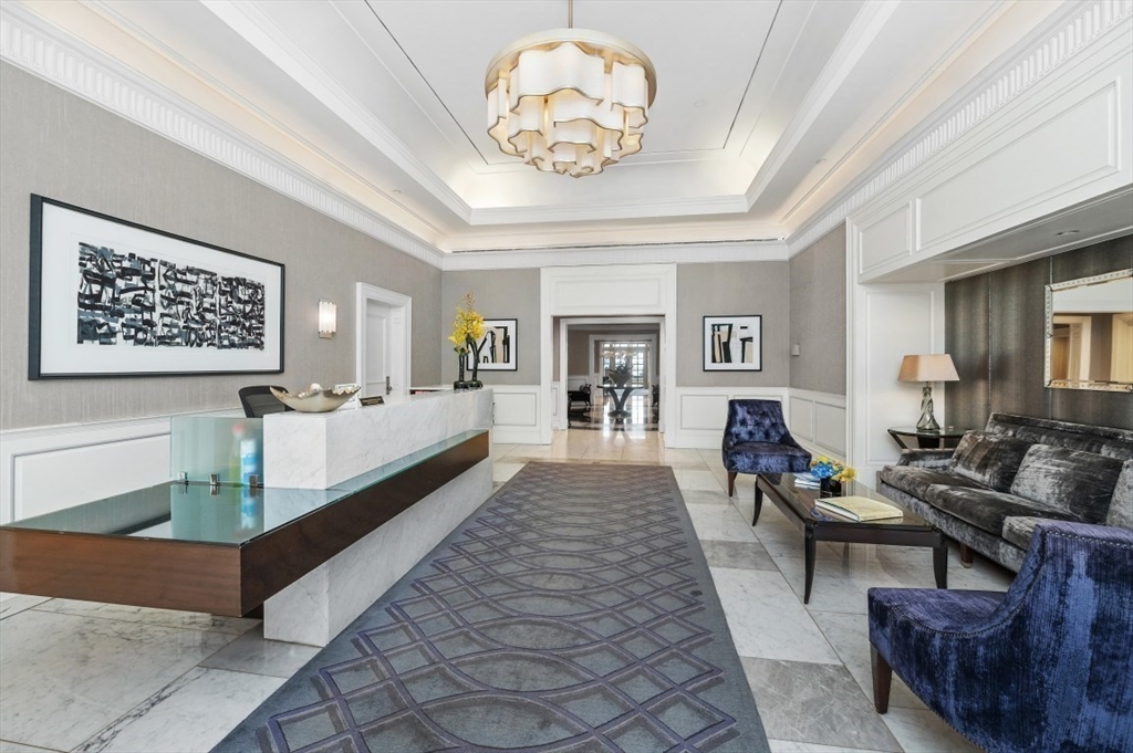 20 Rowes Wharf, Unit PH4 Boston, MA 02110 - Photo 2 of 24 a living room with furniture and a chandelier
