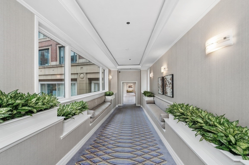 20 Rowes Wharf, Unit PH4 Boston, MA 02110 - Photo 4 of 24 a house with potted plants in front of it