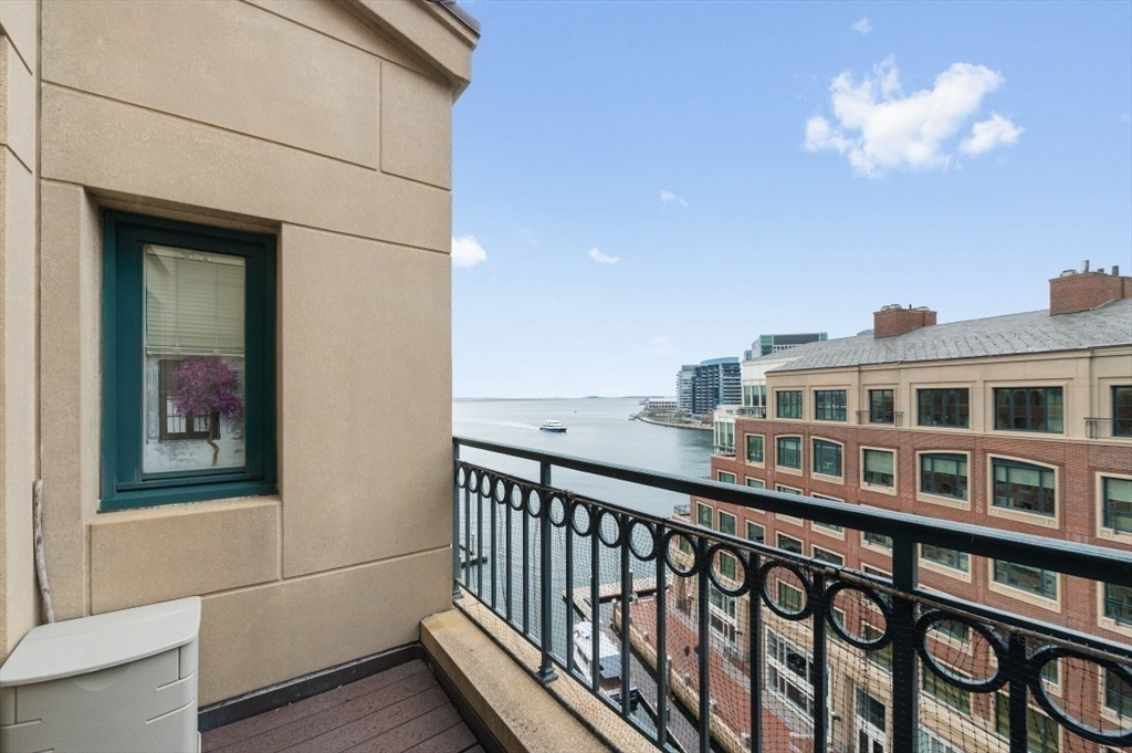 20 Rowes Wharf, Unit PH4 Boston, MA 02110 - Photo 5 of 24 a view of a balcony with a dining table and chairs