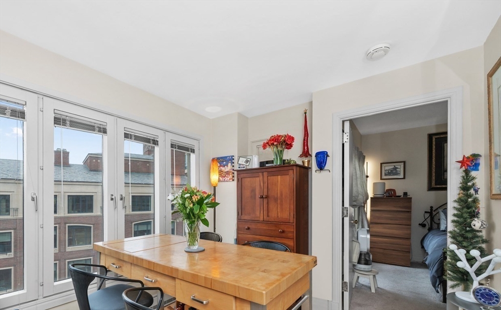 20 Rowes Wharf, Unit PH4 Boston, MA 02110 - Photo 8 of 24 a view of a dining room with furniture and wooden floor