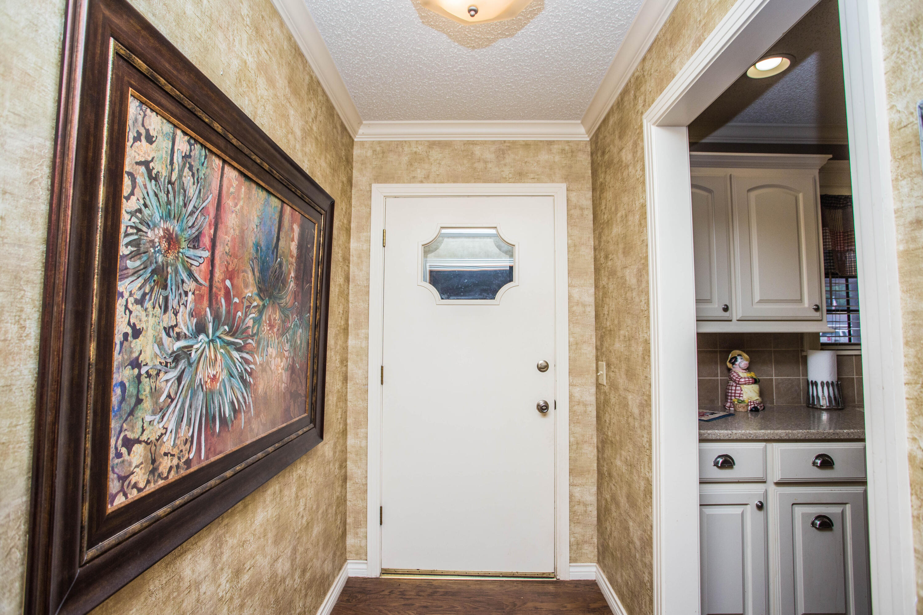 1304 Jefferson Drive Plainview, TX 79072 - Photo 6 of 50 a view of a hallway with wooden floor and door