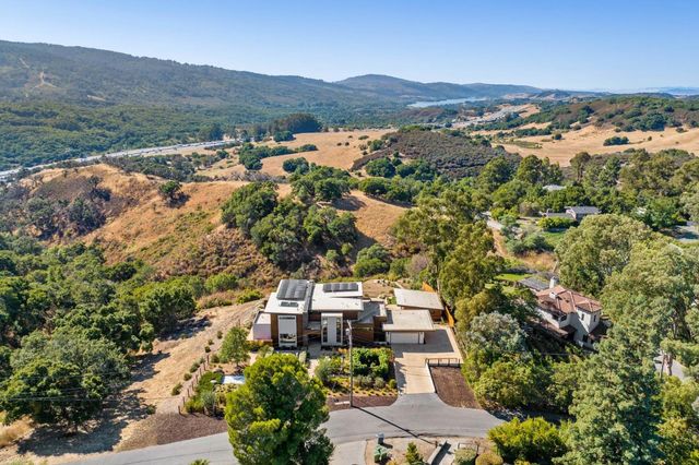 an aerial view of a house with mountain view