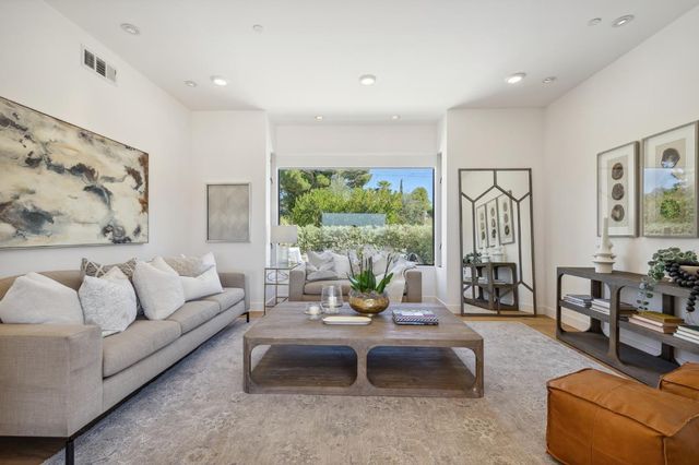 a view of entryway livingroom and hall with wooden floor