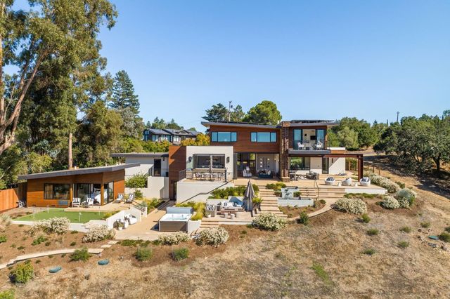 a view of a house with backyard porch and sitting area