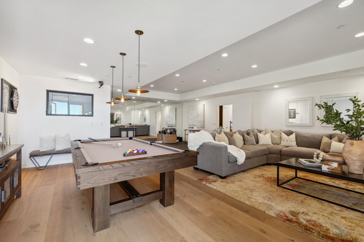 481 West Maple Way Woodside, CA 94062 - Photo 37 of 44 a living room with furniture a rug and a chandelier