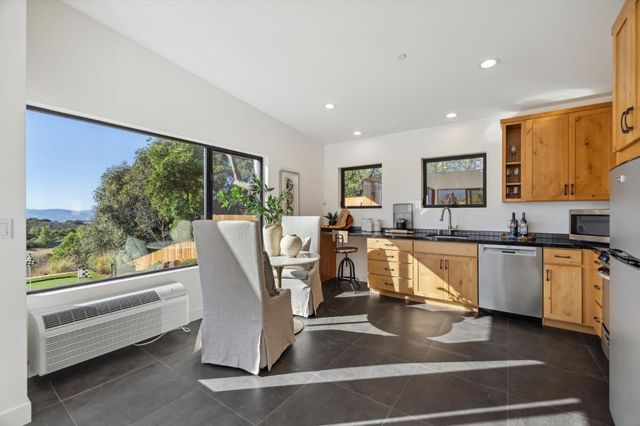 a view of a patio with table and chairs under an umbrella
