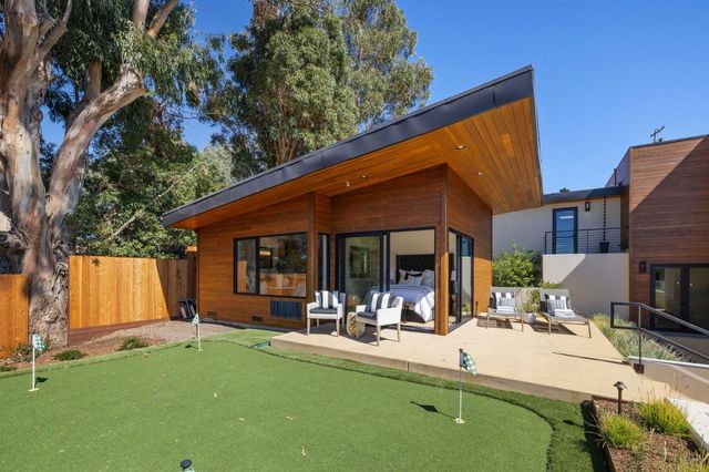 a bathroom with a granite countertop sink toilet a mirror a shower and vanity