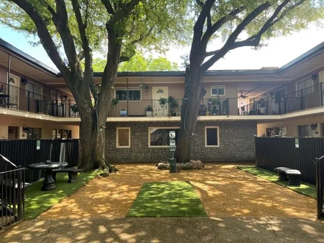 a backyard of a house with table and chairs