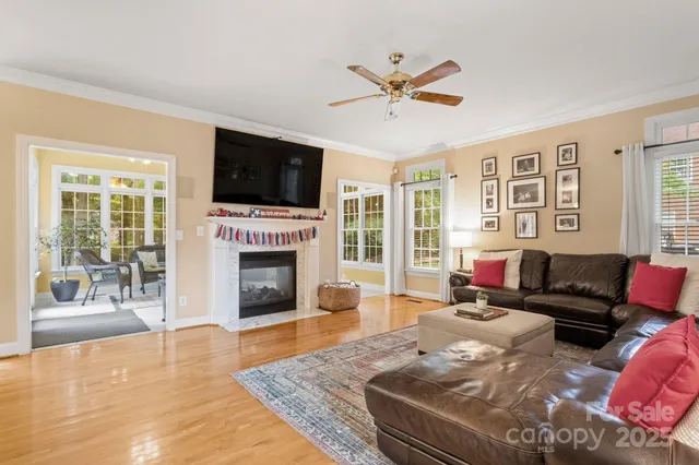 a living room with furniture a flat screen tv and a fireplace