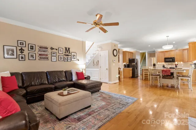 a living room with furniture and kitchen view