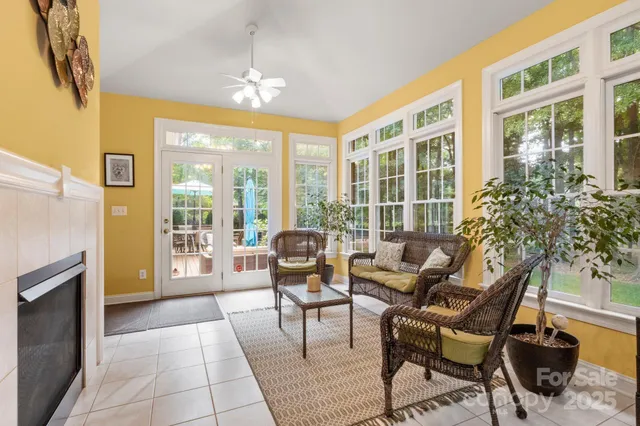 a living room with furniture and a floor to ceiling window