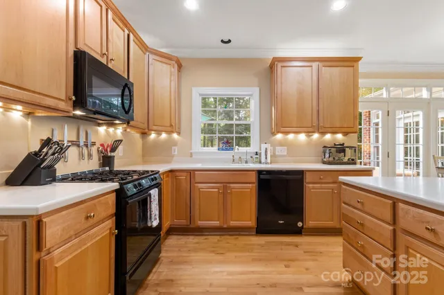 a kitchen with stainless steel appliances granite countertop a stove sink and microwave