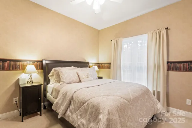 a bed sitting in a bedroom next to a bathroom