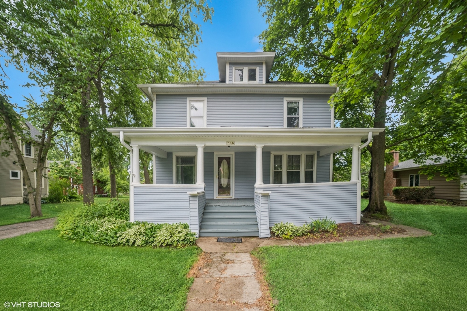 a front view of a house with a garden