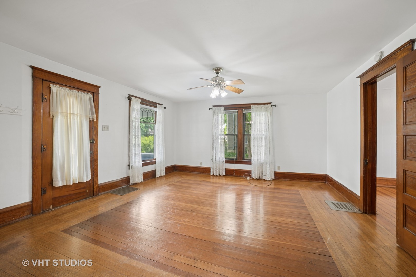 2S234 Harter Road Elburn, IL 60119 - Photo 7 of 24 an empty room with wooden floor and windows
