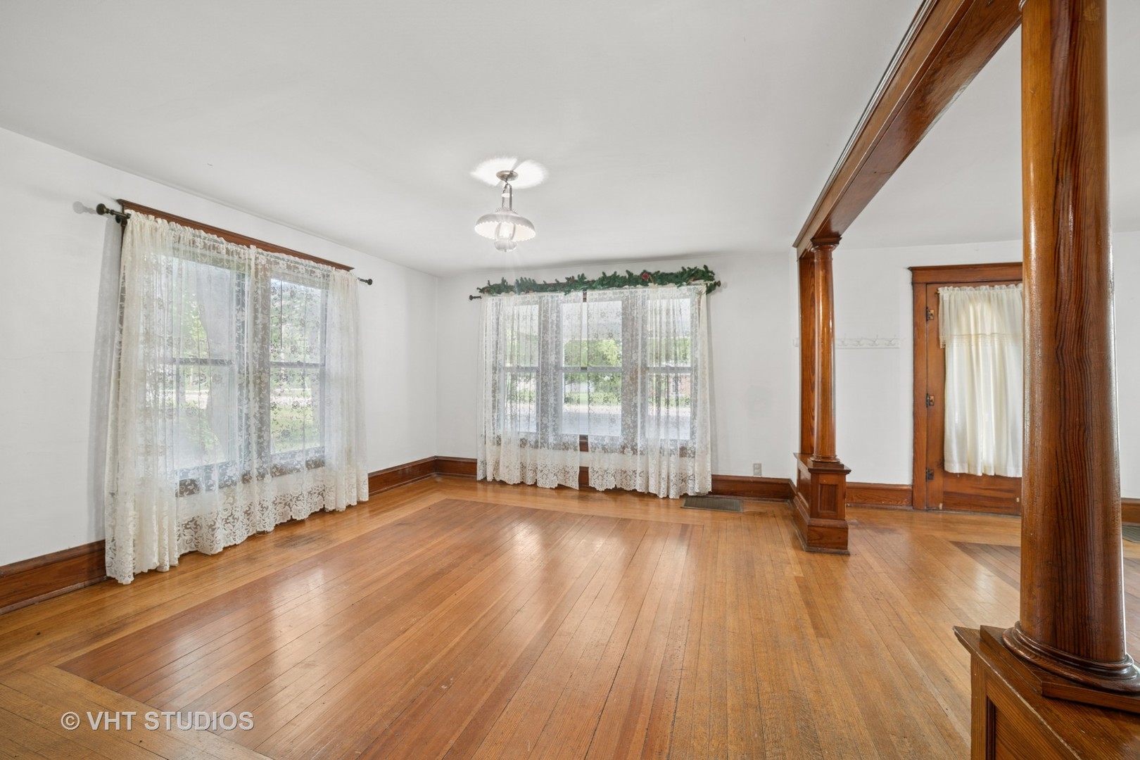2S234 Harter Road Elburn, IL 60119 - Photo 8 of 24 a view of an empty room with wooden floor and a window