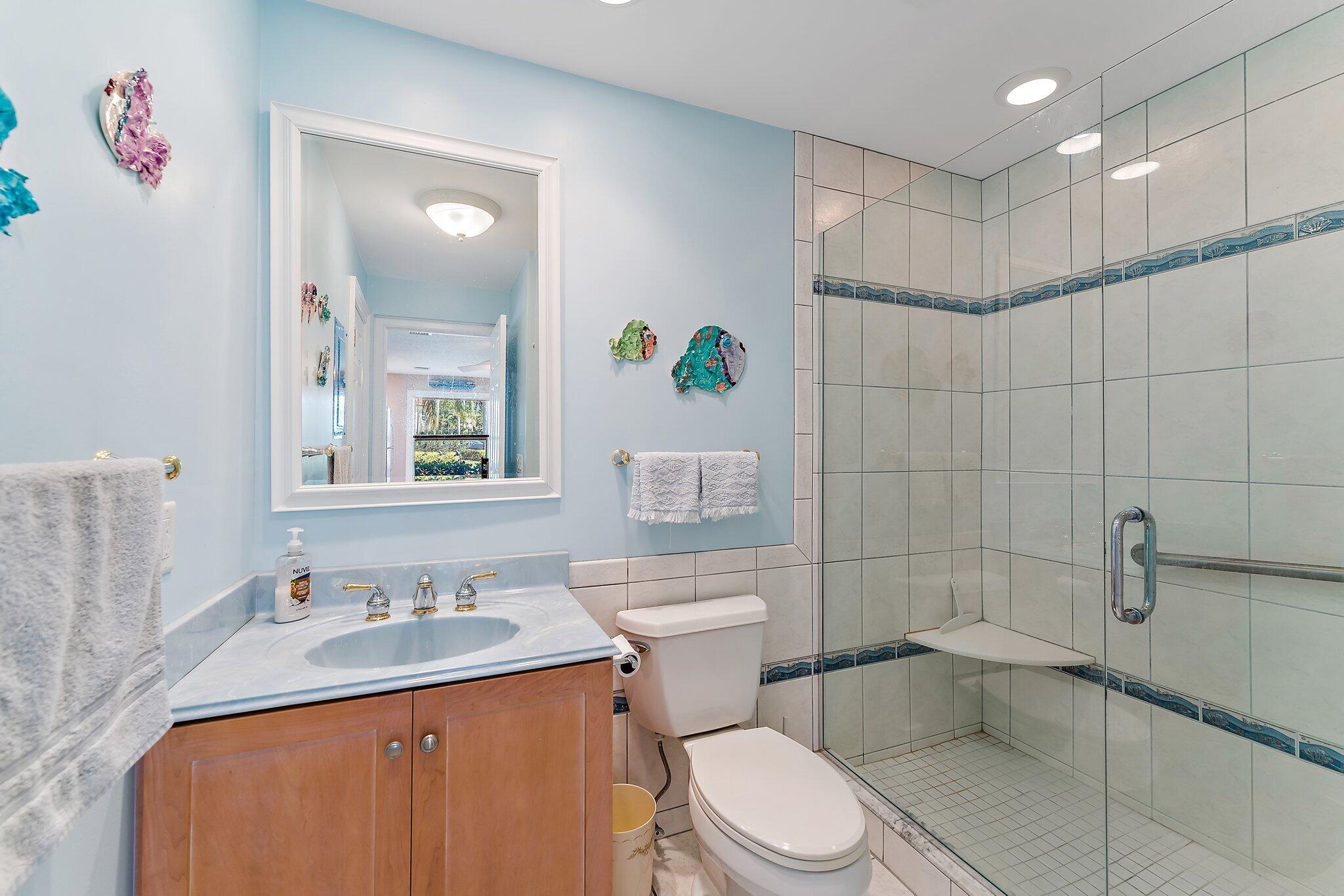 717 Highway 1, Unit 812 Jupiter, FL 33477 - Photo 12 of 41 a bathroom with a sink a toilet and shower